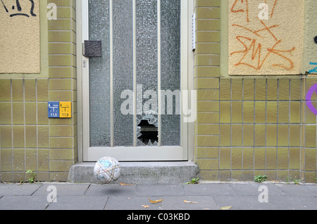 Shot pane of a door and football, Germany, Europe Stock Photo