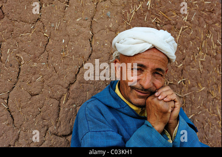 Portrait, elderly Berber man wearing a turban in front of a mud wall, High Atlas Mountains, Morocco, Africa Stock Photo