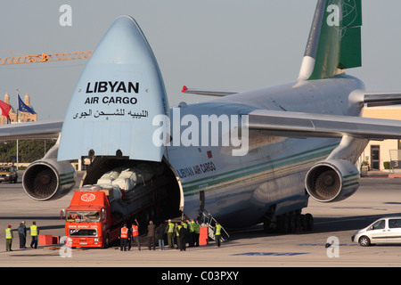 Loading cargo on board a Libyan Air Cargo Antonov An-124 by reversing a trailer truck into the aircraft Stock Photo