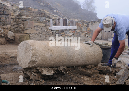 Working in the patio of the ' Domus ' Archaeological site ' Chao Samartin ' Asturias SPAIN Stock Photo