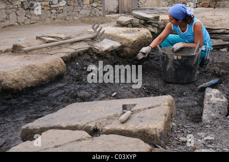 Working in the patio of the ' Domus ' Archaeological site ' Chao Samartin ' Asturias SPAIN Stock Photo