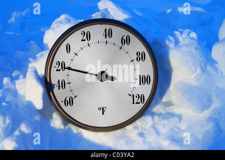 A temperature gauge in the snow registering greater than 20 degrees below zero Fahrenheit. Stock Photo