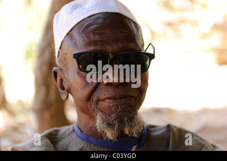 Senior Muslim man with broken sun glasses in the Dogon village of Yendouma. Mali. Stock Photo