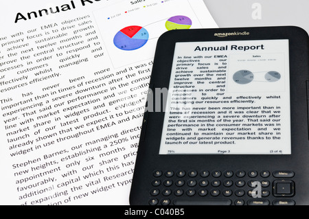 Amazon Kindle showing a company annual report with a printed copy Stock Photo