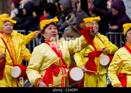 Female Falun Gong practitioners play instruments while marching in the annual 2011 Lunar New Year parade in Queens, New York Stock Photo