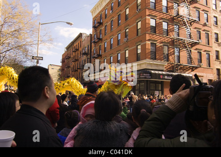 Yellow Dragon scaring away demons in New York City's 2011 Chinese New Year Parade. Stock Photo