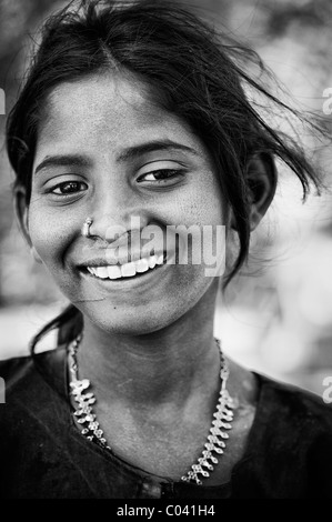 Happy young poor lower caste Indian street teenage girl smiling. Black and white. Andhra Pradesh, India Stock Photo