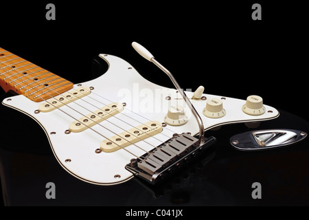 Black Fender American Standard Stratocaster with retro fitted Fender Noiseless Pickups on black background Stock Photo