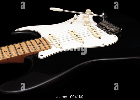 Black Fender American Standard Stratocaster with retro fitted Fender Noiseless Pickups on black background Stock Photo