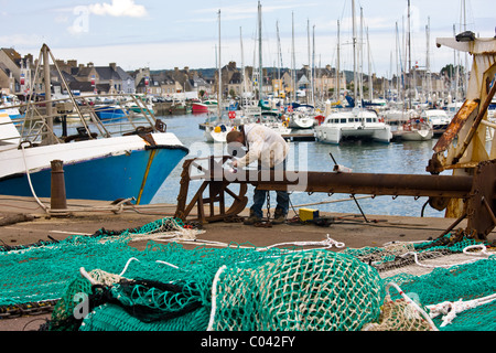 Welder at work at boatyard at Channel port of St Vaast La Hougue in Normandy, France Stock Photo