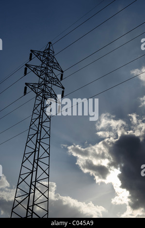 Power lines pylon in blue sky and clouds background, High Voltage mast ...