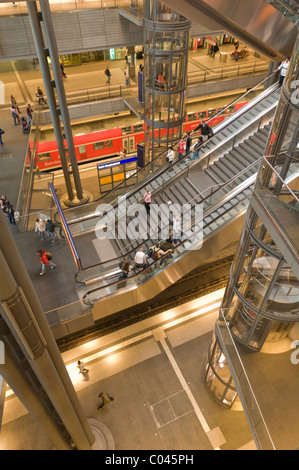 Travellers ride the escalators inside Berlins main train station, the Hauptbahnhof Stock Photo