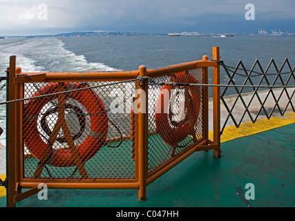 View looking back across harbor from aft deck of Ferry leaving Staten Island, New York, USA Stock Photo