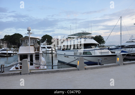 Boats docked in Harbour Town marina at dusk.  The marina is located on Hilton Head Island in South Carolina. Stock Photo