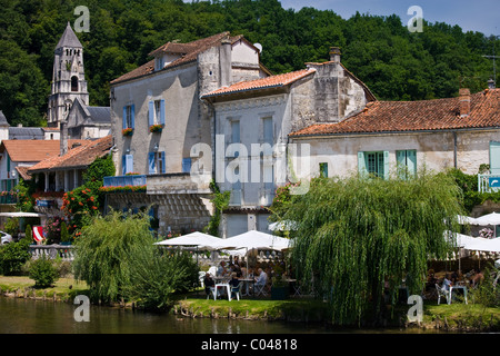 Brantome Abbey and outdoor cafe by River Dordogne at Brantome in Northern Dordogne, France Stock Photo