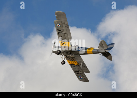 A vintage Tiger Moth biplane flying at Compton Abbas airfield in England Stock Photo