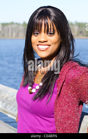 Successful young African American business woman at a lake setting. Stock Photo