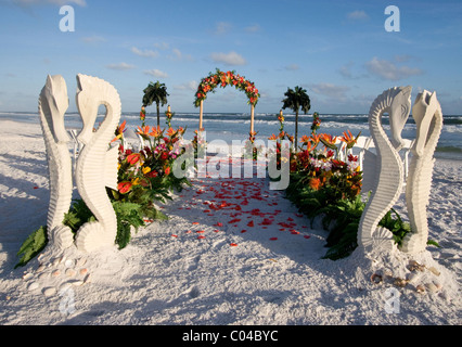 Seahorses guard the path to the wedding archway lined with rose pedals. Stock Photo