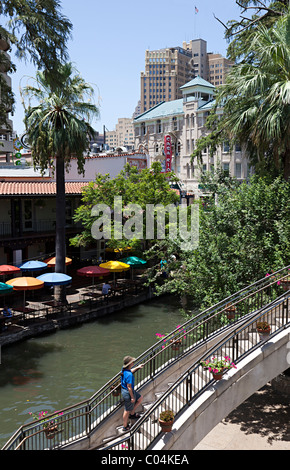 Woman walking up steps beside river on the River Walk in San Antonio Texas USA Stock Photo