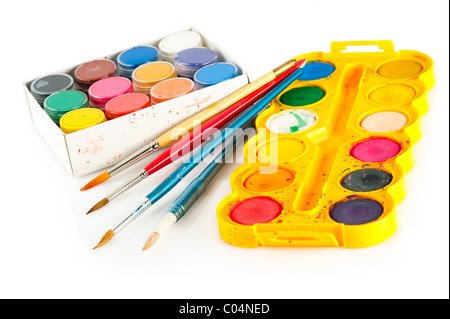 Set for painting. Palettes of watercolor paint and used brushes on white background Stock Photo