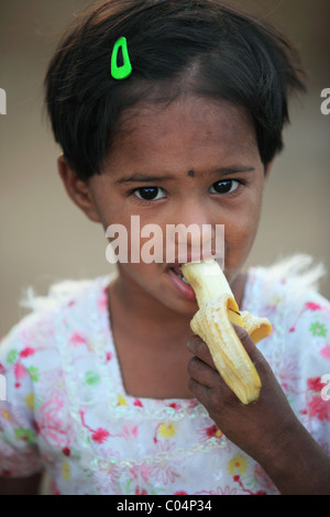 girl eating a banana Andhra Pradesh South India Stock Photo - Alamy