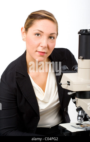 Portrait of young researcher at microscope. Stock Photo