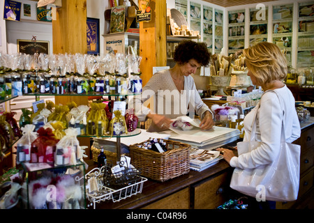 Shopper buying at artisan soaps Martin de Candre specialist savon shop Mestre at Fontevraud L'Abbaye, Loire Valley, France Stock Photo