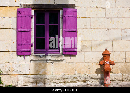 Brightly painted window and traditional water hydrant at Parnay near Saumur in the Loire Valley, France Stock Photo