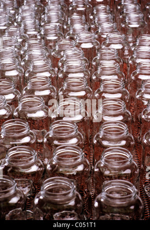 Glass bottles on the assembly line of a glass product manufacturing plant Stock Photo