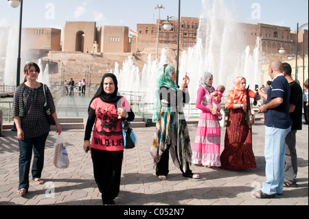A group of Kurdish people socializing in the main public square, below the old city walls and citadel, in the city of Erbil, Kurdistan, northern Iraq. Stock Photo
