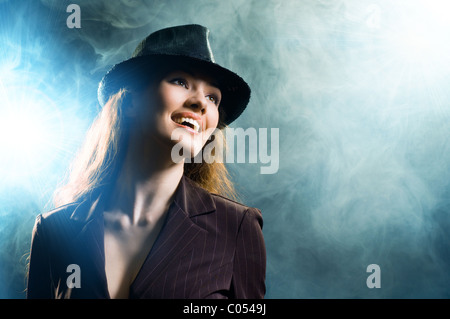 girl in the smoke enlightened with spotlights Stock Photo
