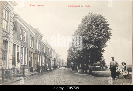 Man and girl standing on a street in 1908 on a vintage postcard Stock Photo
