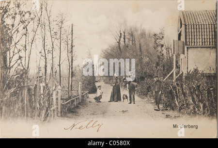 Mailman and family on sandy road in Muiderberg in the Netherlands on old postcard Stock Photo