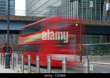 Two buses going under a bridge in Canary Wharf, London Stock Photo