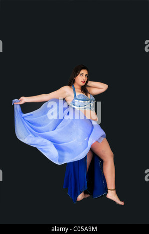 Belly dancer in blue On black Background Stock Photo