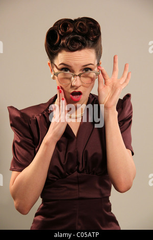 Old fashioned woman looking shocked Stock Photo