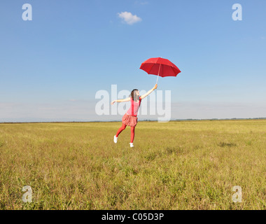 Young woman holding red umbrella Stock Photo