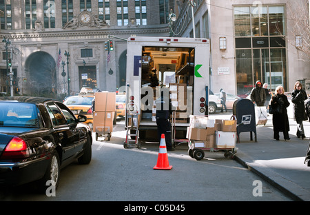 A FedEx employee sorts packages for delivery in Midtown Manhattan in New York Stock Photo