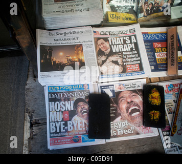 Headlines of newspapers on a newsstand in New York report on Pres. Hosni Mubarak leaving office in Egypt Stock Photo