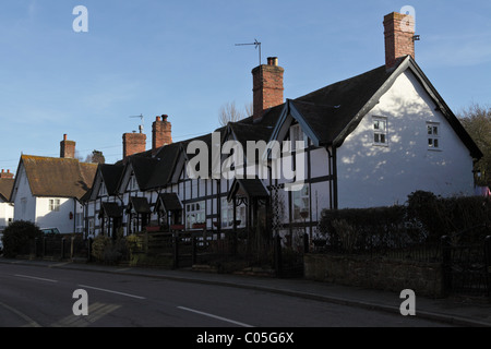 Terrace of Grade II Listed black and white cottages,situated opposite the Post Office in Acton Burnell, Shropshire. Stock Photo