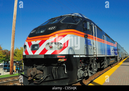 A eastbound Metra commuter train departs the station heading for Chicago. Bartlett, Illinois, USA. Stock Photo