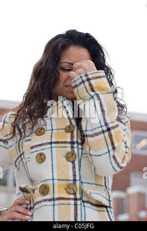 A woman experiencing a painful headache or she could be stressed out. Stock Photo