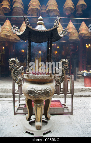 China, Hong Kong, New Territories, Tai Po area. Inside famous Man Mo Temple, hanging coils of burning incense used as offering. Stock Photo