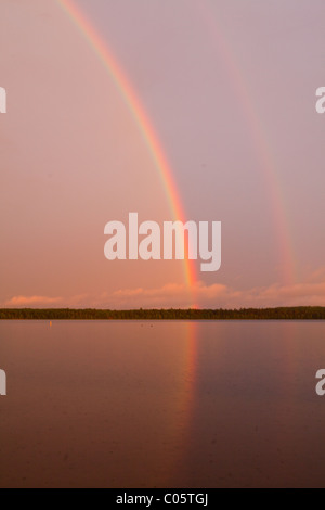 Rainbow over a lake in the Northwoods of Wisconsin. Stock Photo