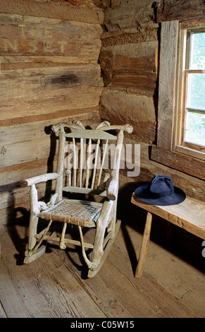 The Museum of Appalachia at Norris, Tennessee, USA. A rocking chair sits in the corner of the log church Stock Photo