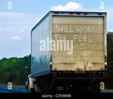 Box truck with 'Will work for Fuel' slogan written on the rear door while being driven on an interstate highway in Maryland USA Stock Photo