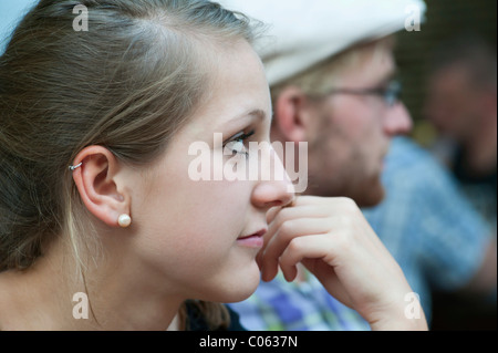 A young man and a young woman looking a bit bored, Germany, Europe Stock Photo