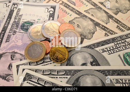 Euro coins on U.S. dollar banknotes, symbolic image of exchange rates, strong and weak currency Stock Photo