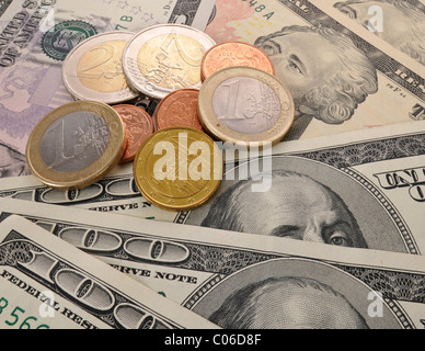 Euro coins on U.S. dollar banknotes, symbolic image of exchange rates, strong and weak currency Stock Photo