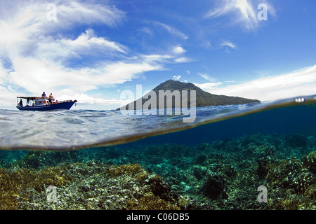 Manado Tua Vulcan, Indonesia, seen from half in and and half out of the ocean. Stock Photo